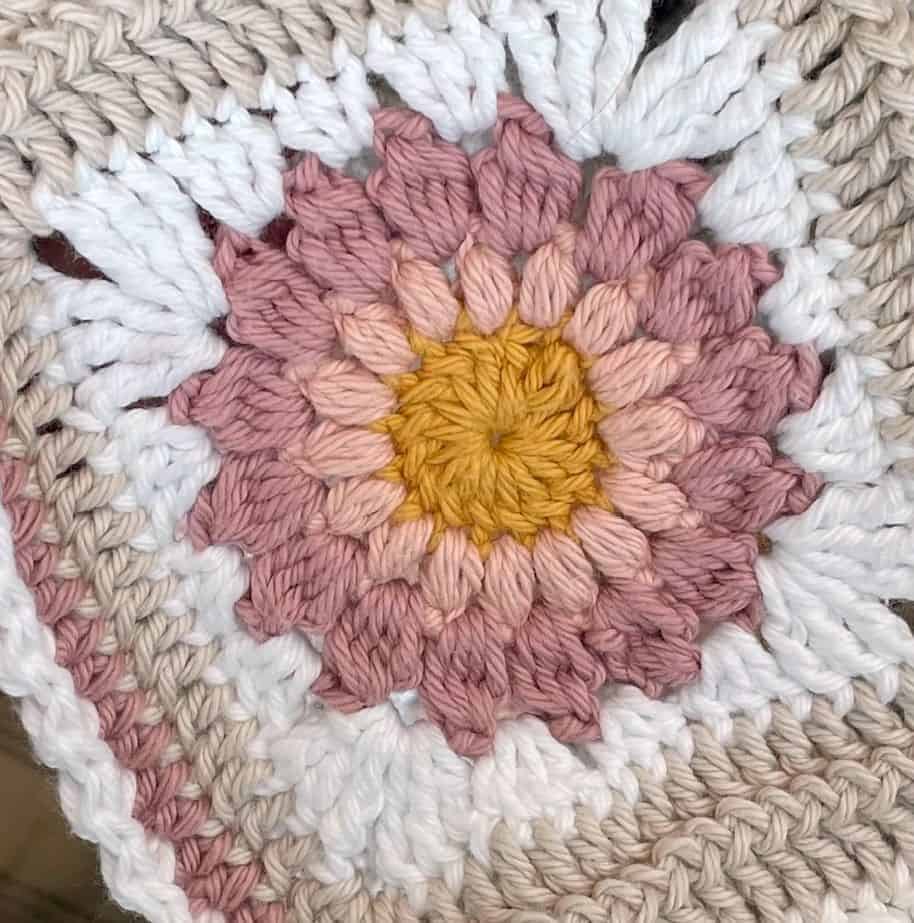 Close up of crochet Sunburst Granny Square in cotton yarn